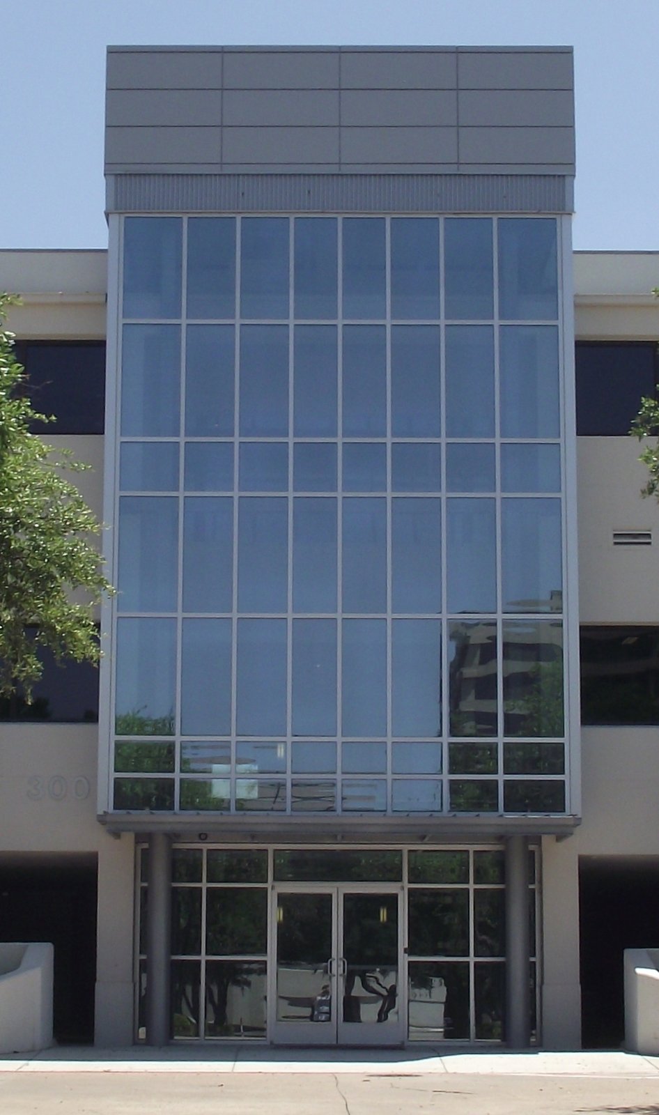 Multi-story curtain wall above a commercial glass entrance.