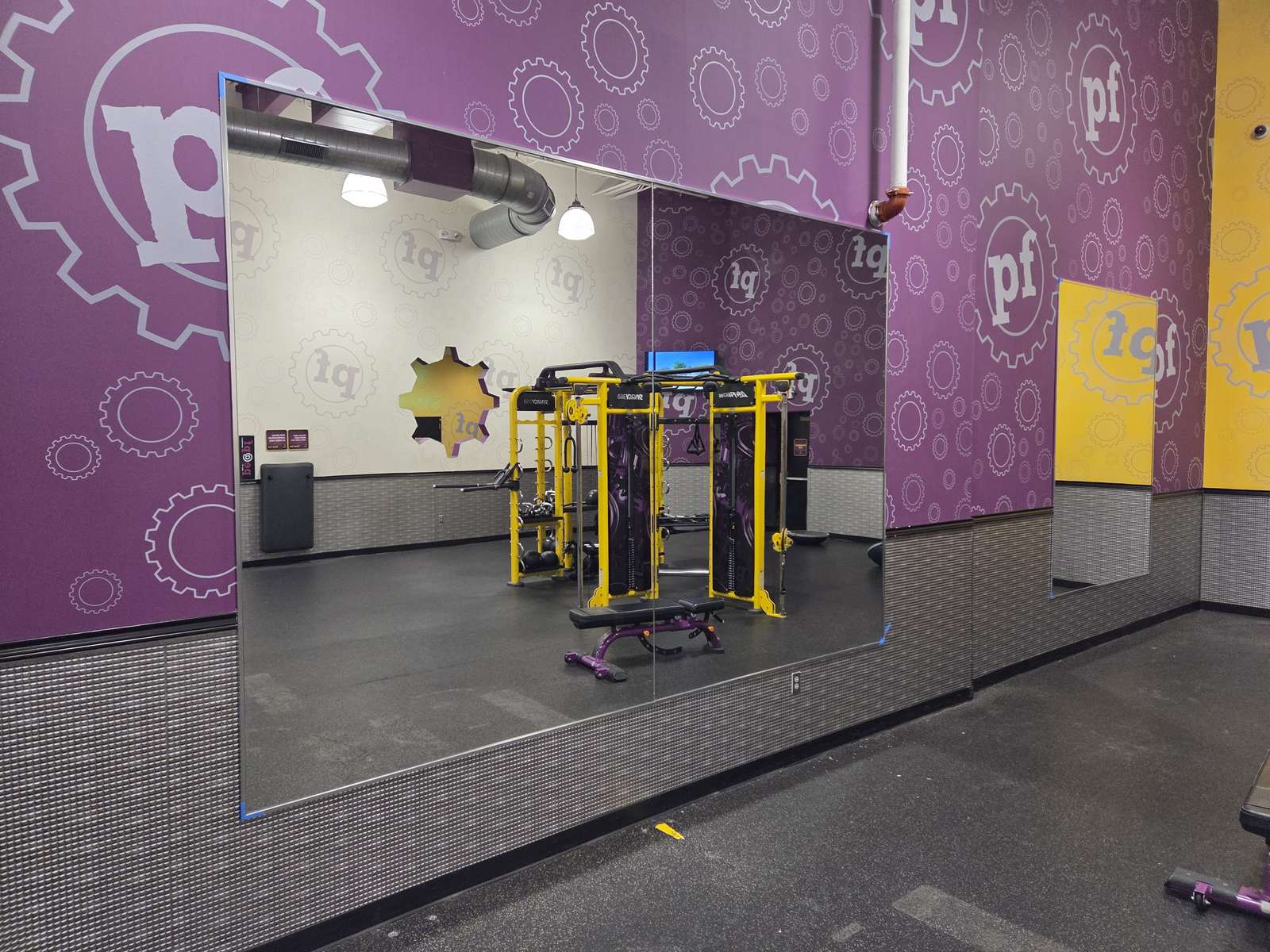 Large wall mirrors installed in a gym.