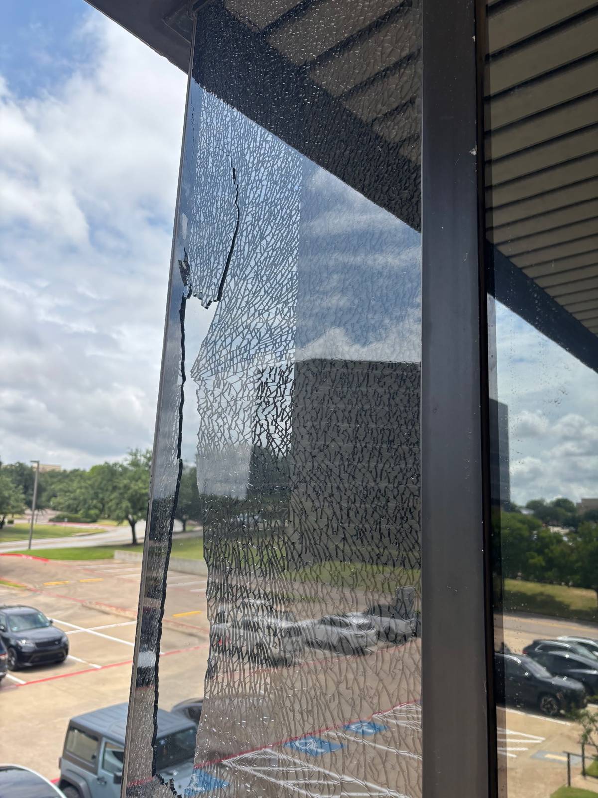 Shattered glass in an upper-floor commercial window.