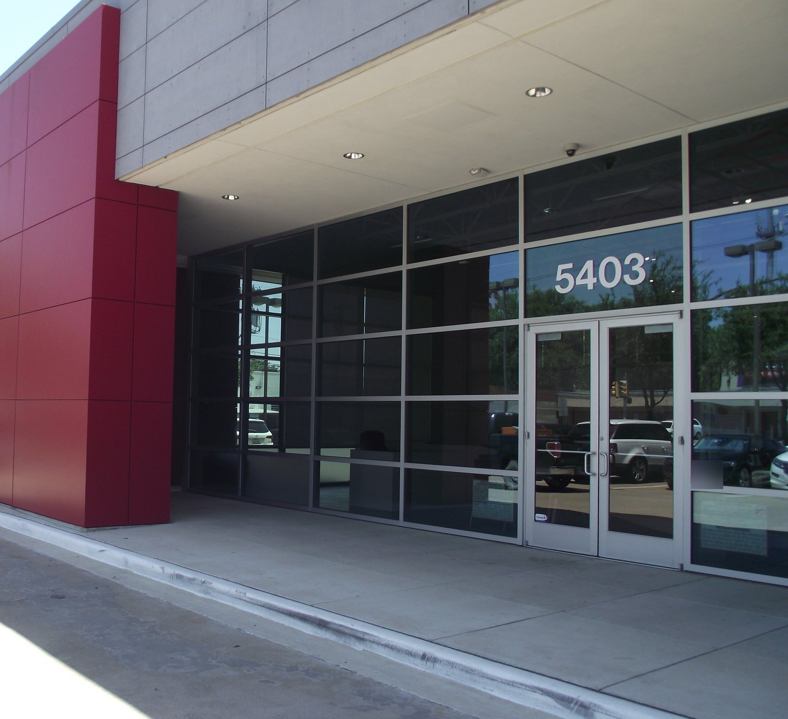 Aluminum storefront entrance beneath a canopy.